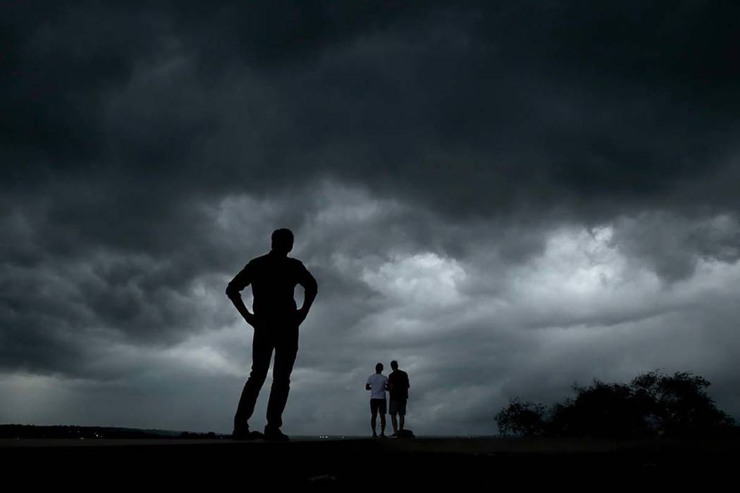 People watch from the Liberty Memorial as a severe storm that dropped several tornados earlier ...