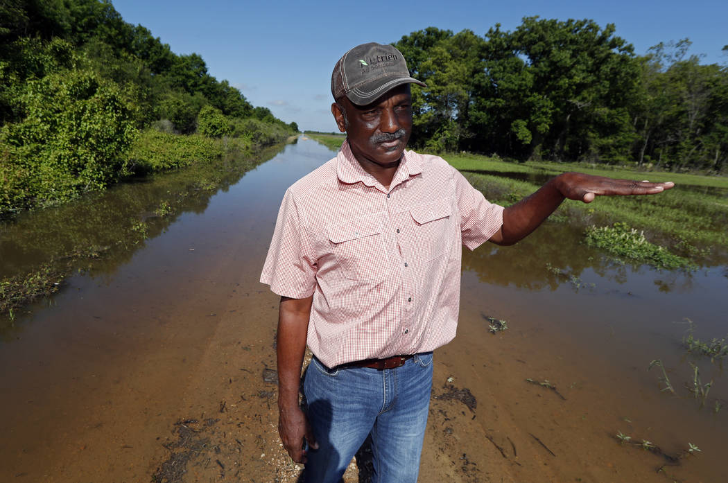 Larry Walls, a farmer and businessman stands May 23, 2019, at the edge of a backwater flooded r ...