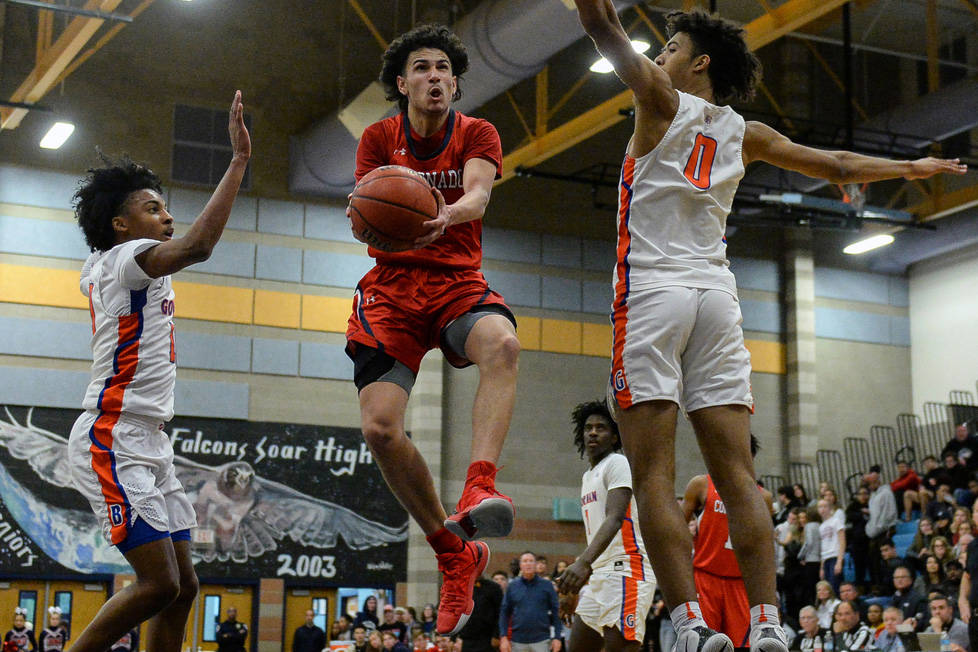 Coronado's Richard Isaacs (2) jumps up to take a shot while being guarded by Bishop Gorman's Za ...