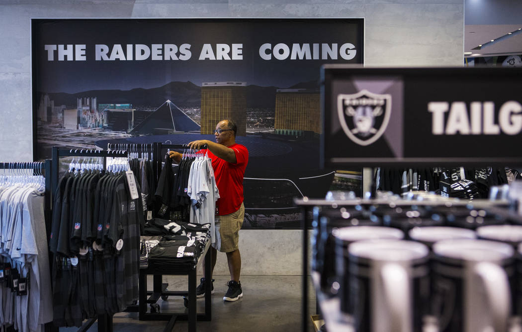 BJ Freeman, of Texas, looks through shirts and jerseys at The Raider Image store at the Galleri ...