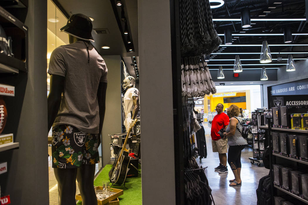 BJ Freeman and Sabrina Freeman, both of Texas, shop at The Raider Image store at the Galleria a ...