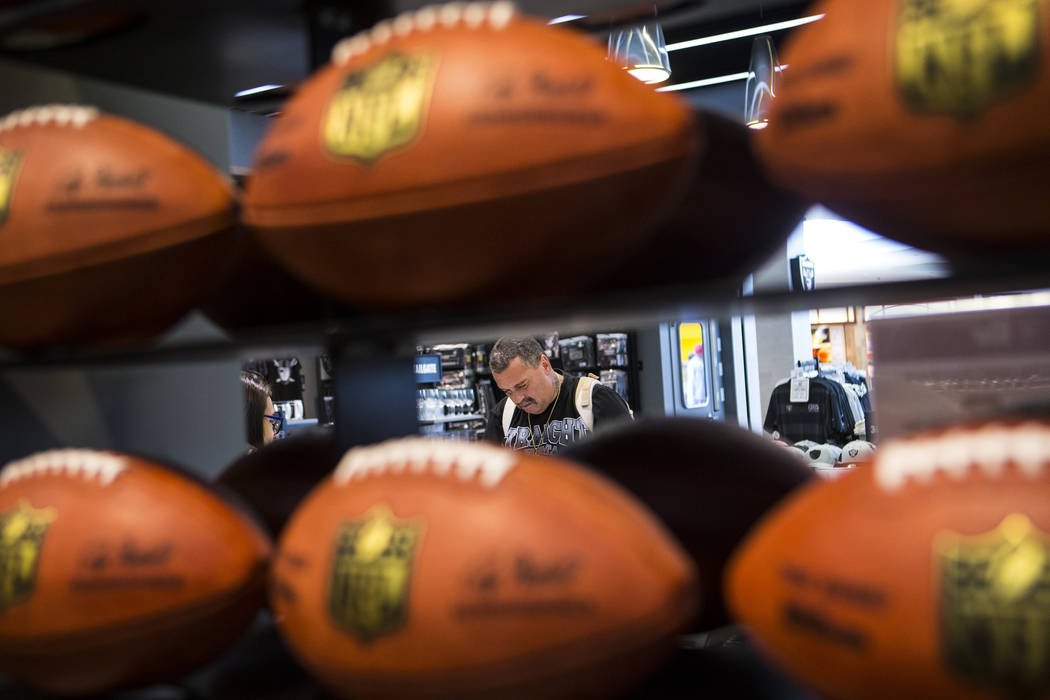 Nickolaus Gerencser of Baldwin Park, Calif., buys items at The Raider Image store at the Galler ...