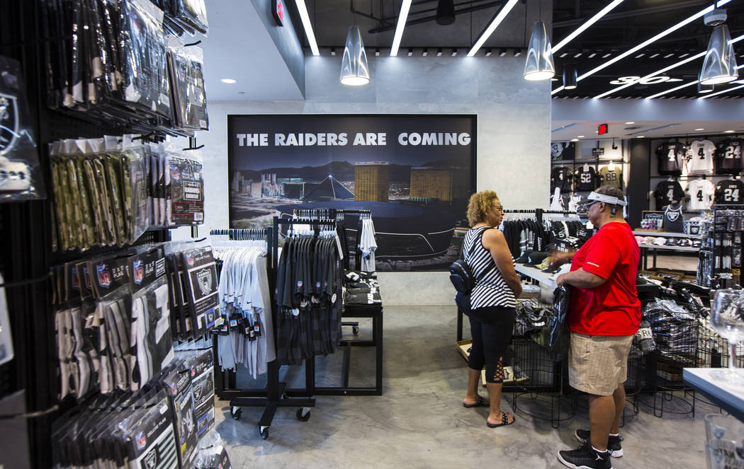 Sabrina Freeman, left, and BJ Freeman, both of Texas, shop at The Raider Image store at the Gal ...