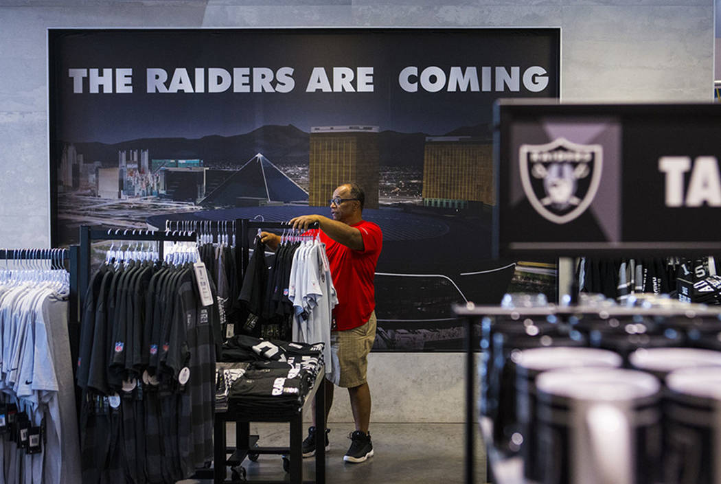 BJ Freeman, of Texas, looks through shirts and jerseys at The Raider Image store at the Galleri ...