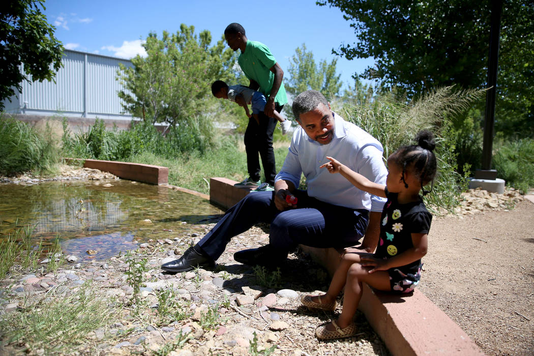 U.S. Rep. Steven Horsford, D-Nev., talks to Ryan Williams, 2, as her father O'Brian Williams ho ...