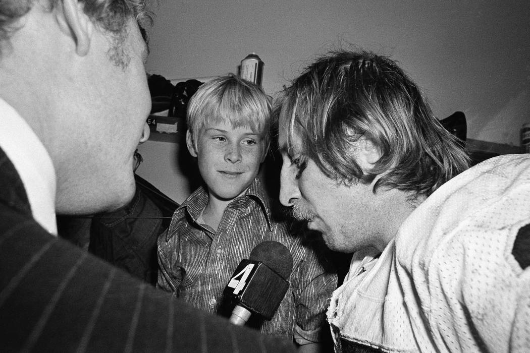 Ten-year-old Fred Biletnikoff Jr., center, looks in admiration at his father, one of the stars ...