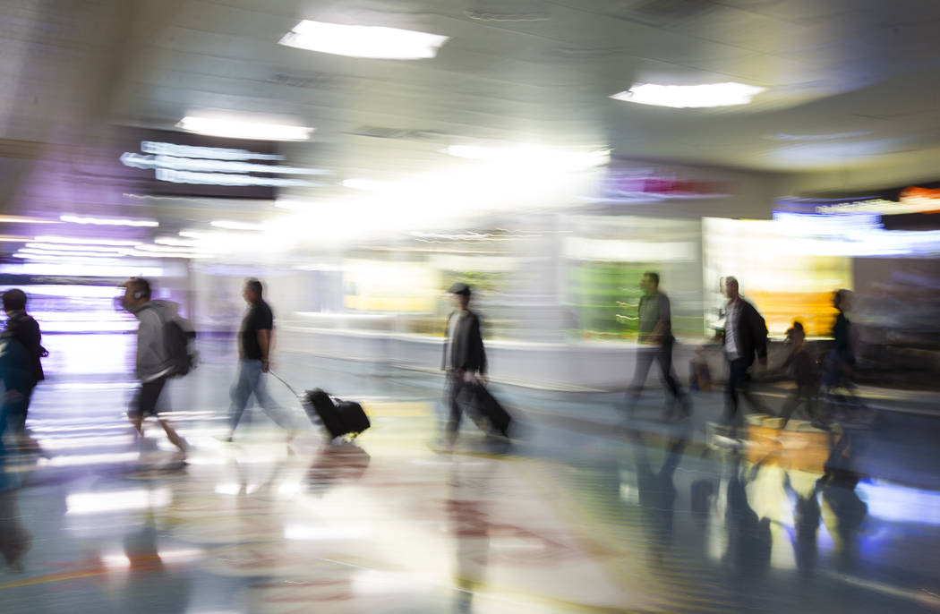 Travelers walk through baggage claim in Terminal 1 at McCarran International Airportin Las Vega ...