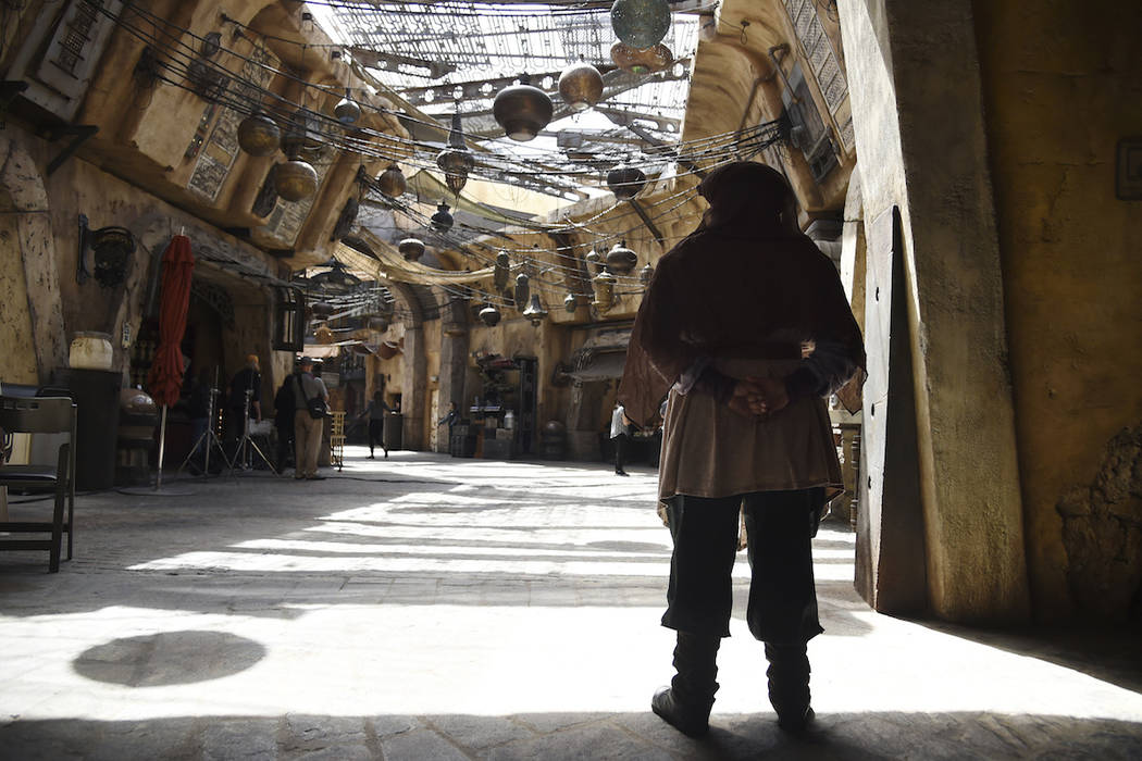 A character looks out to the marketplace in the Black Spire Outpost during the Star Wars: Galax ...