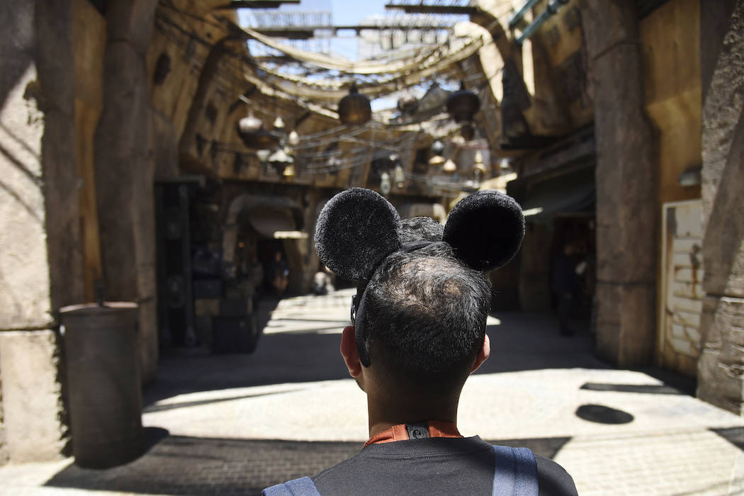 A visitor peers down the marketplace of the Black Spire Outpost during the Star Wars: Galaxy's ...