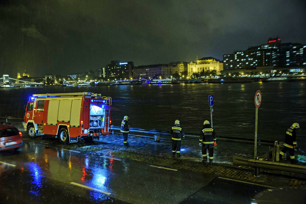 Rescuers search for victims on the river bank early Thursday, May 30, 2019 after a tourist boat ...