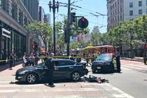 Police work at the scene where a stolen Kia SUV (not pictured) traveling at a high speed crashe ...