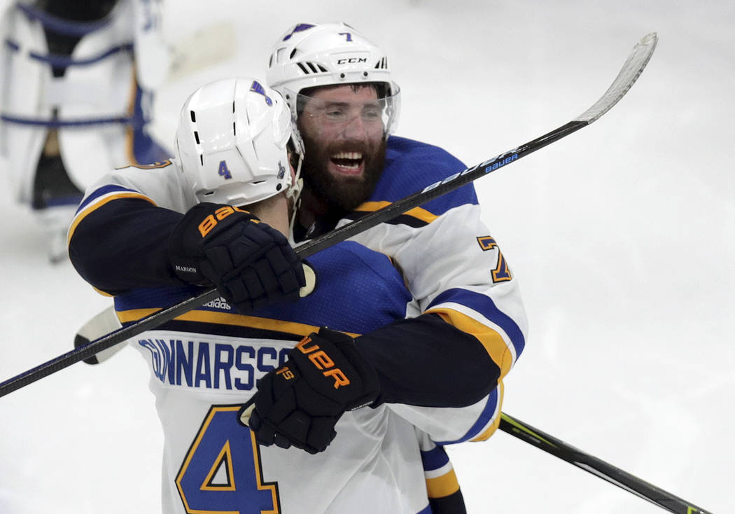 St. Louis Blues' Carl Gunnarsson (4), of Sweden, is congratulated by Pat Maroon, rear, after he ...