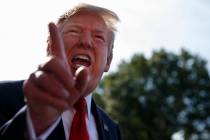 President Donald Trump talks with reporters before departing on Marine One for the Air Force Ac ...