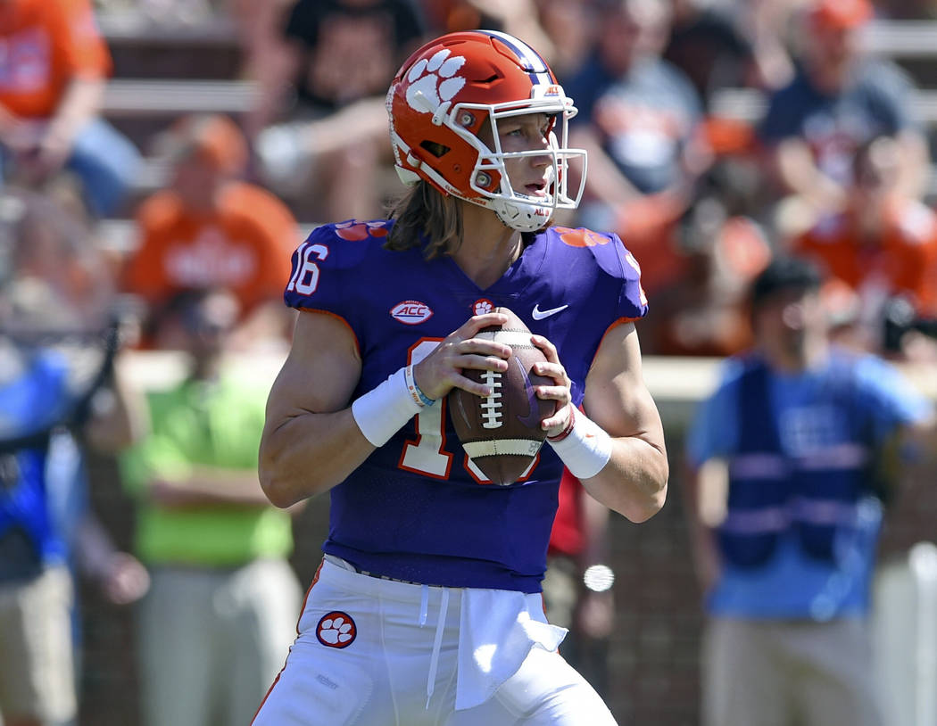 Clemson's Trevor Lawrence drops back to pass during Clemson's annual Orange and White NCAA coll ...
