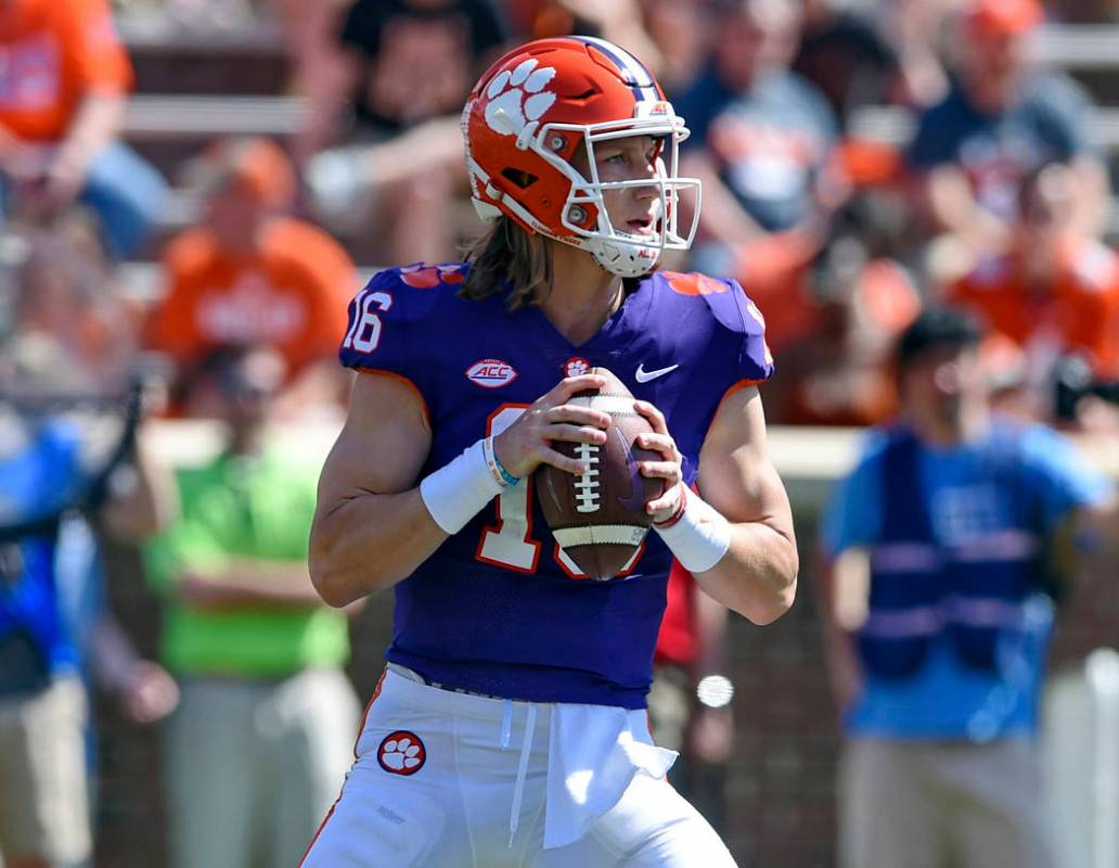 Clemson's Trevor Lawrence drops back to pass during Clemson's annual Orange and White NCAA coll ...