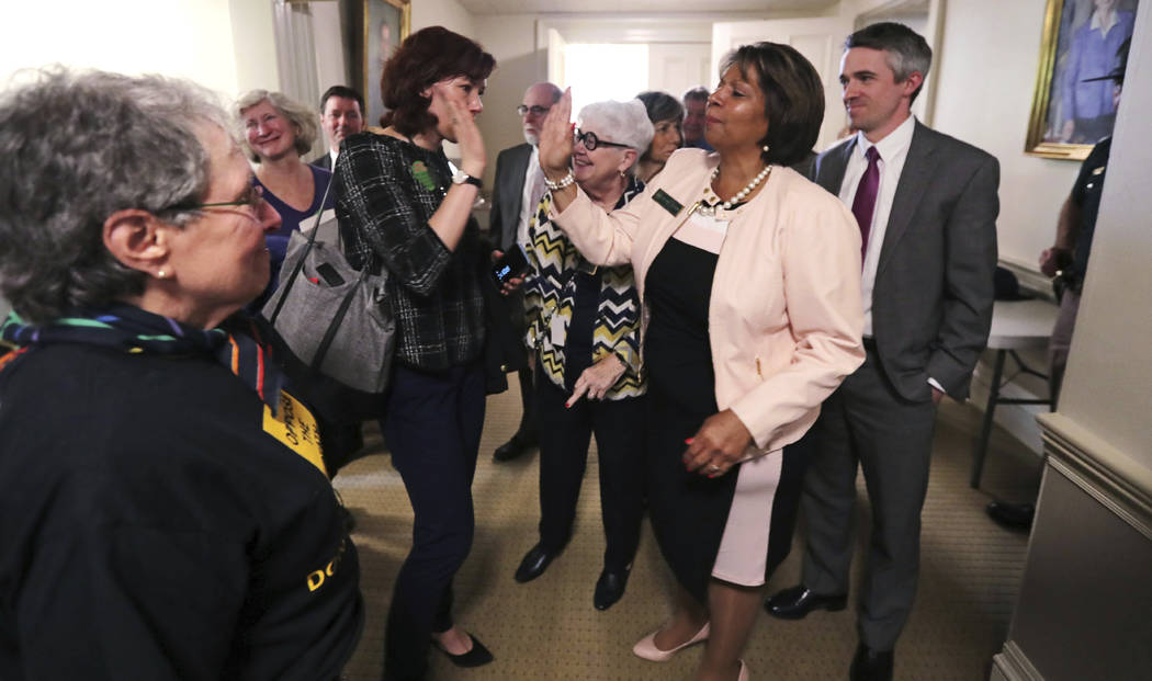 State Sen. Melanie Levesque, D-Hillsborough, right, is congratulated following a vote on the de ...