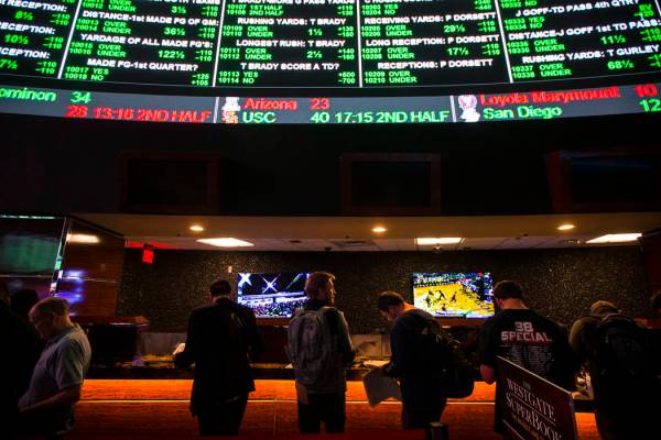 Bettors line up to place prop bets for the Super Bowl at the Westgate Superbook in Las Vegas on ...