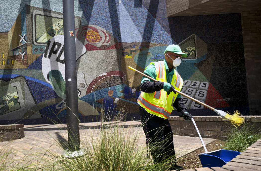 A cleaning crew sweeps up in front of LAPD Central Community Police Station in downtown Los Ang ...