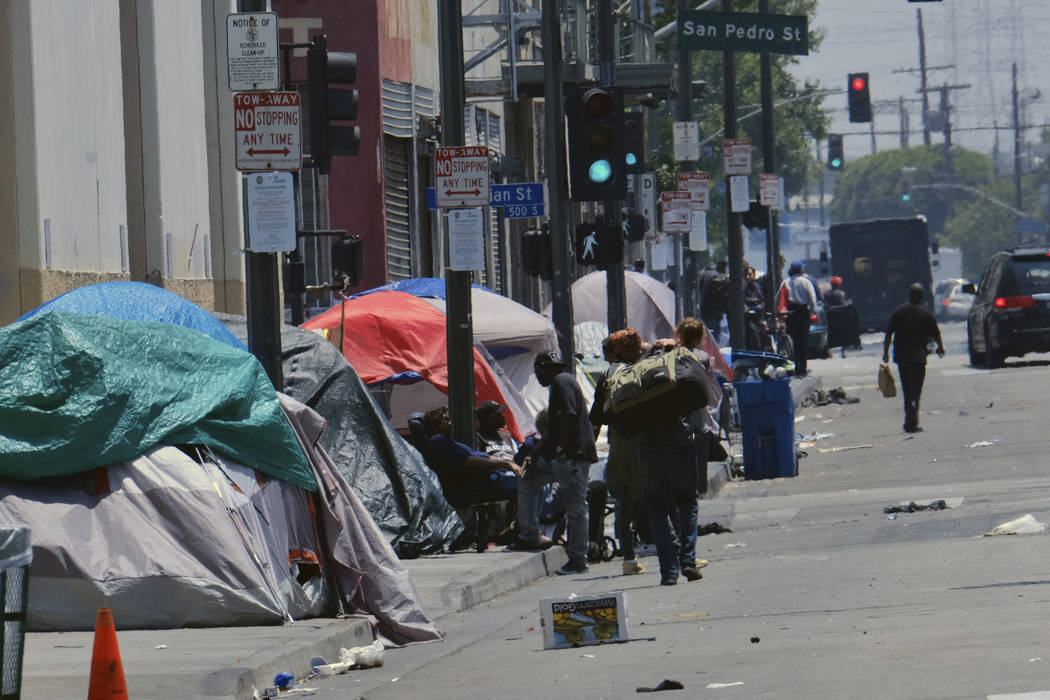 Tents housing homeless line a street down the street from LAPD Central Community Police Station ...