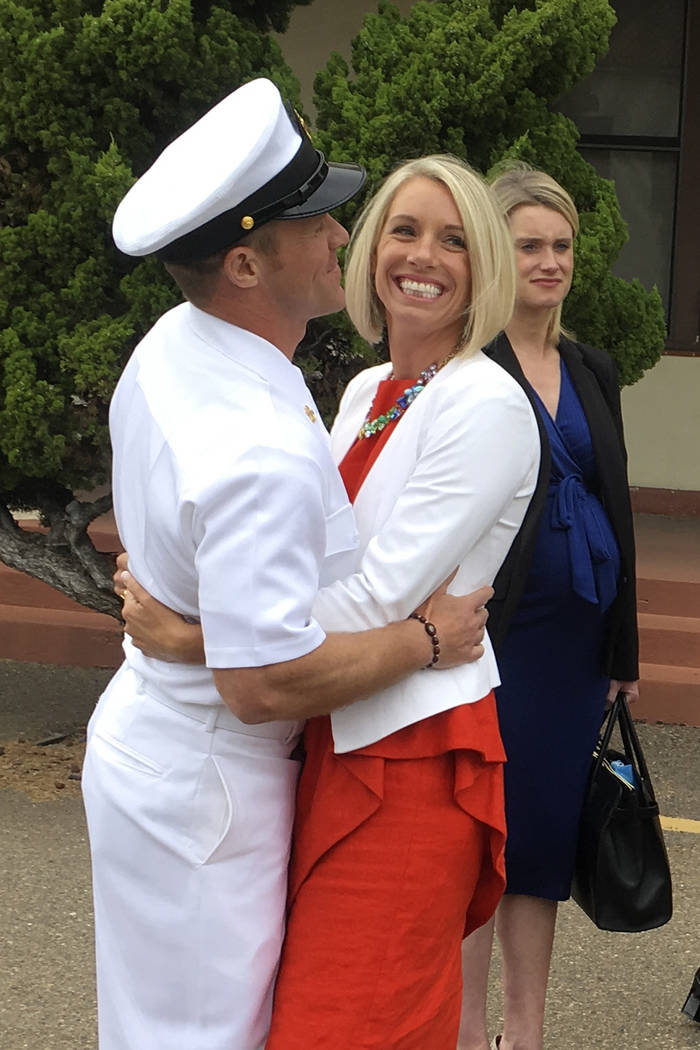 Navy Special Operations Chief Edward Gallagher, left, hugs his wife, Andrea Gallagher, after le ...