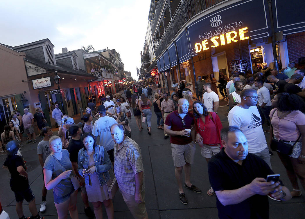 People gather to watch on Bourbon Street at Bienville Street after a Louisiana state trooper sh ...