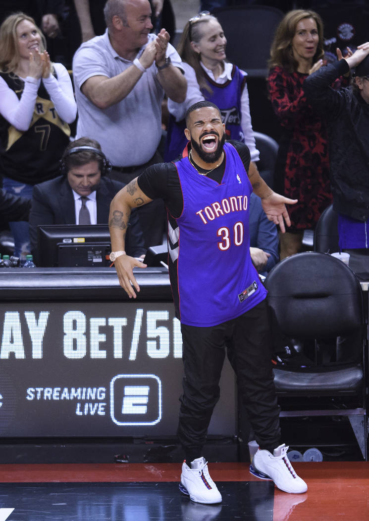 Rapper Drake reacts courtside as the Toronto Raptors play the Golden State Warriors during the ...