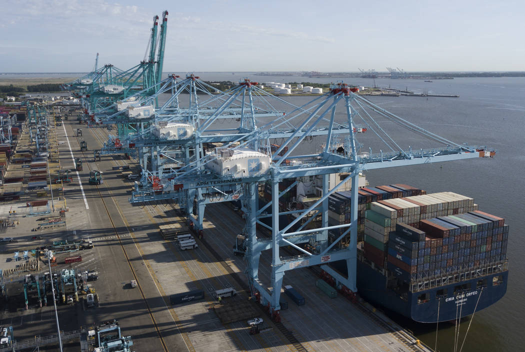 FILE - In this May 10, 2019, file photo a container ship is unloaded at the Virginia Internatio ...