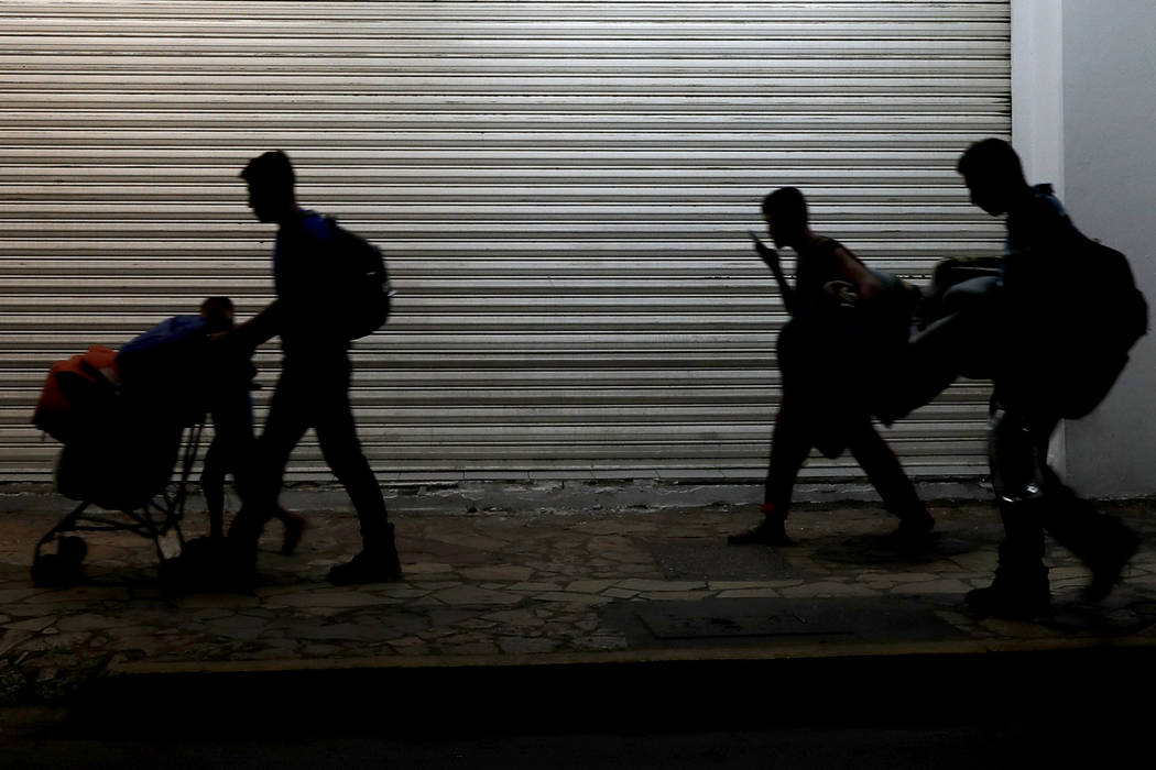 Migrant families camped in a park leave in the middle of the night as they are pushed out by Me ...