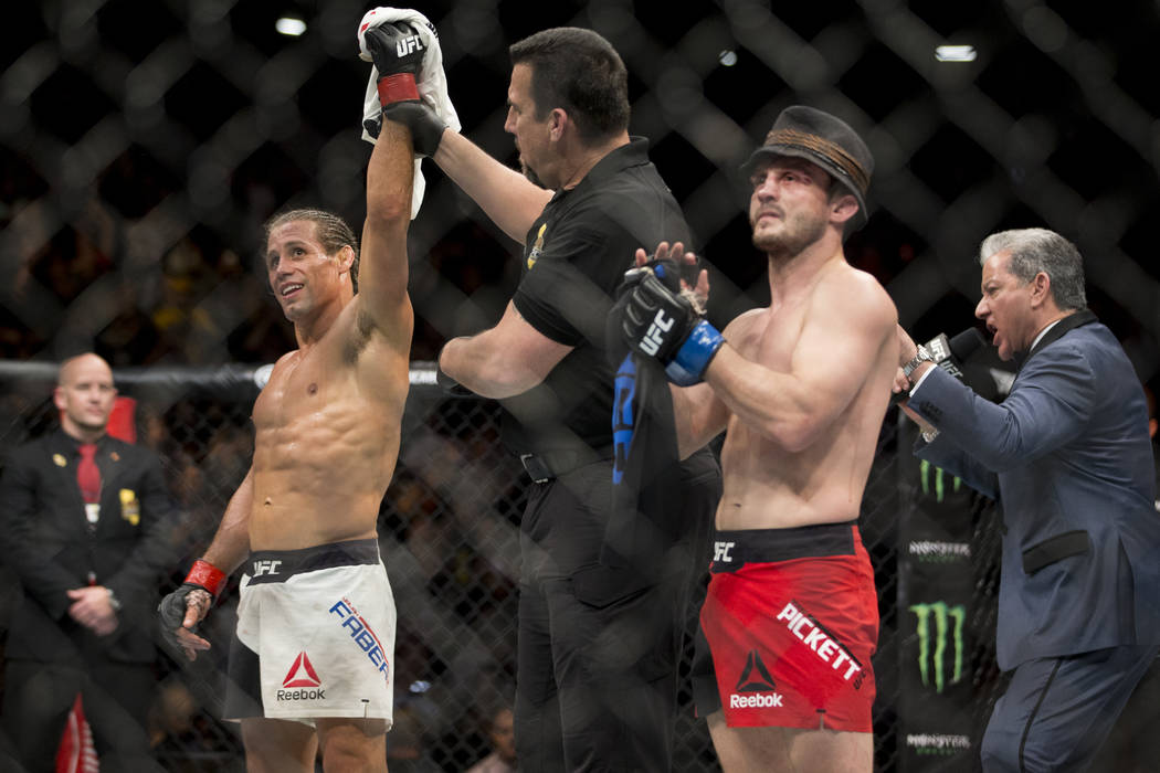 Urijah Faber, left, is called the winner against Brad Pickett in the UFC Fight Night bantamweig ...
