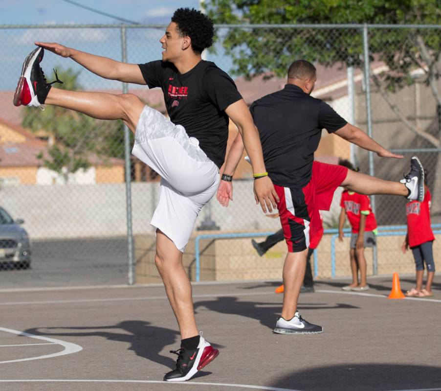 UNLV player Marvin Coleman II, left, demonstrates a stretch during a youth clinic hosted by UNL ...