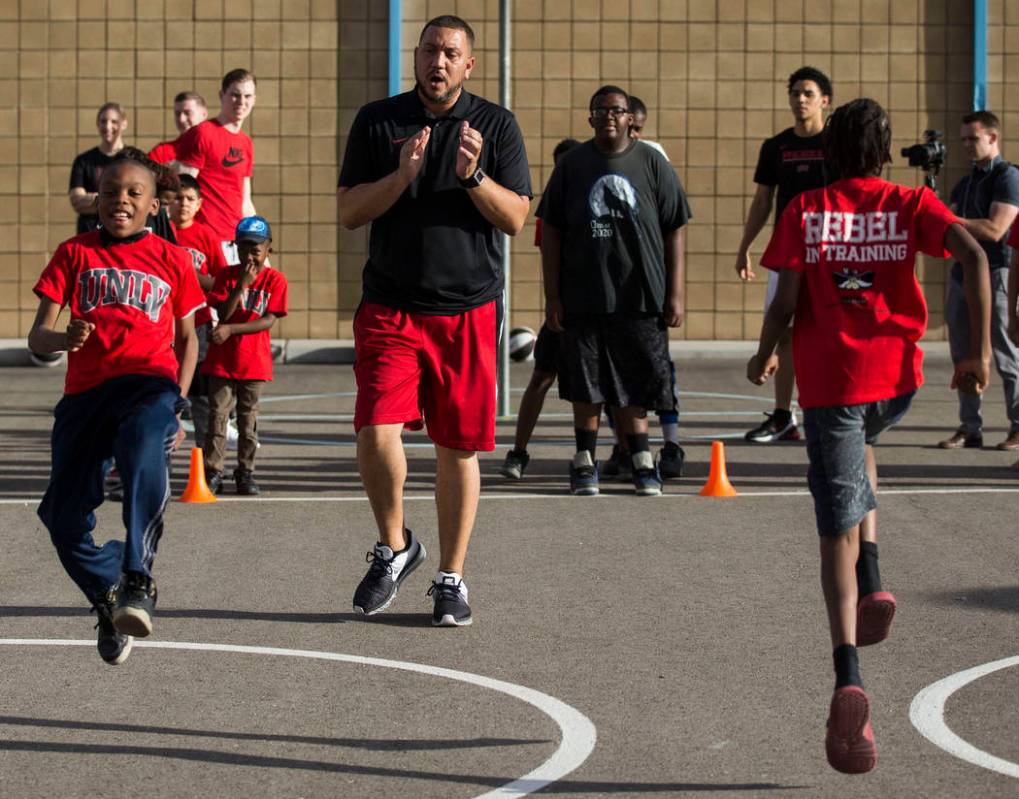 UNLV assistant coach DeShawn Henry, center, cheers on kids with the Nevada Youth Network during ...
