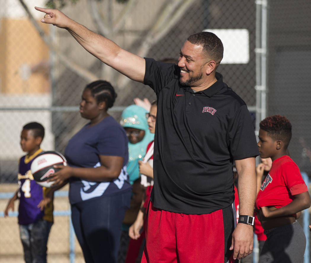 UNLV assistant coach DeShawn Henry, middle, cheers on kids with the Nevada Youth Network during ...