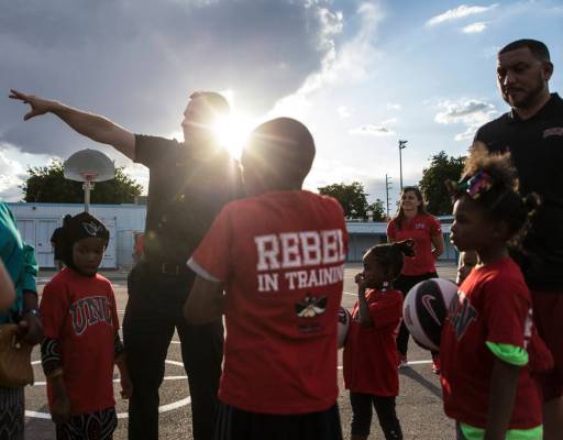 UNLV head basketball coach T.J. Otzelberger, top/left, directs kids during a youth clinic at th ...