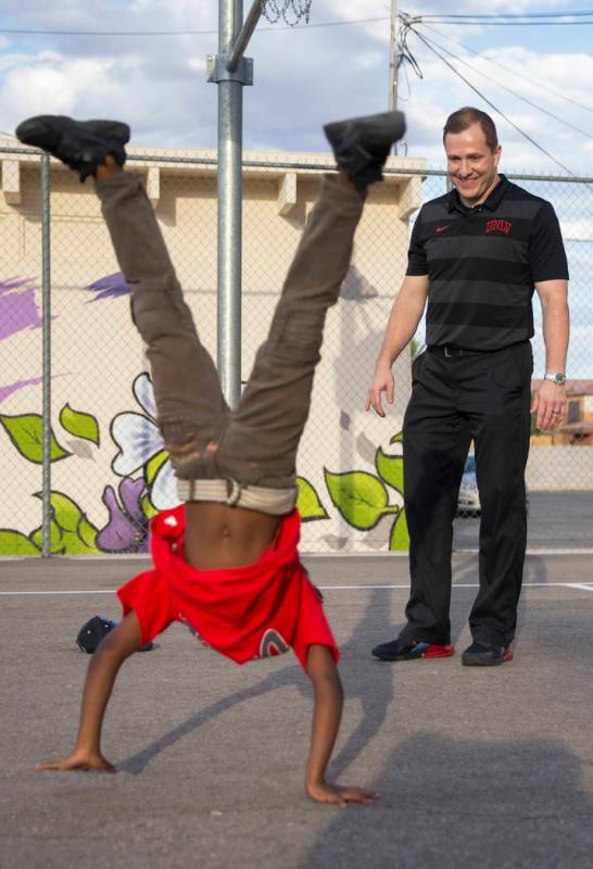 Devori Brown, left, 6, shows UNLV head basketball coach T.J. Otzelberger his moves during a you ...