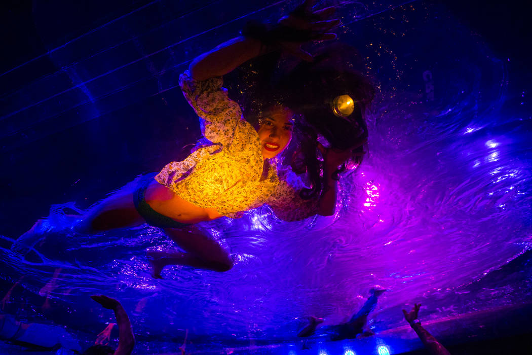 A cast members in "Fuerza Bruta" performs on a mylar suspended pool as part of a medi ...