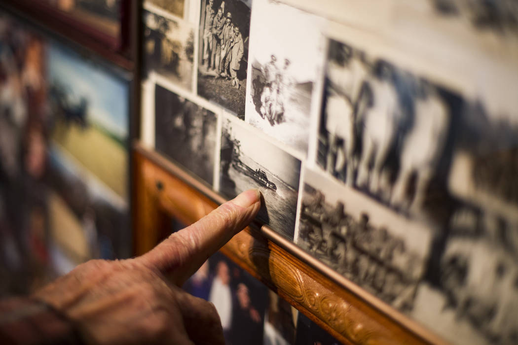 Onofrio "No-No" Zicari, 96, shows the Review-Journal photo of the Battle of Normandy ...