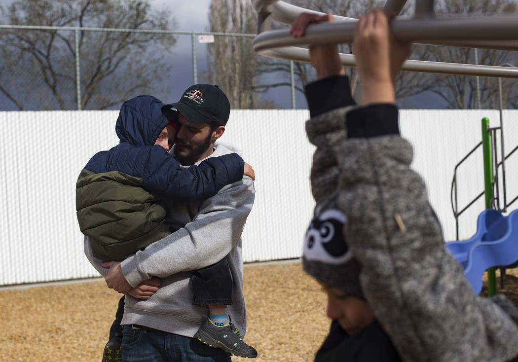 Daniel Shaw holds Bentley Brown, 4, at a park in Winnemucca, Nev., Tuesday, April 9, 2019. Shaw ...