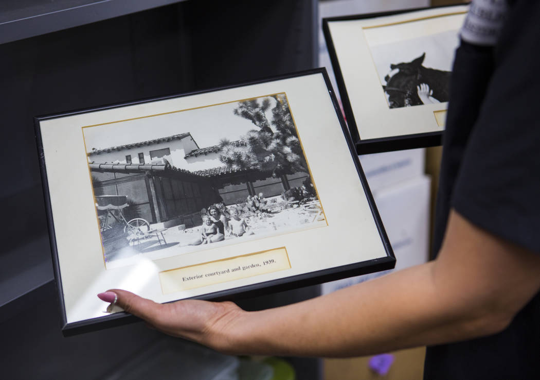 Deirdre Clemente, associate director of the UNLV public history program, holds a pair of framed ...