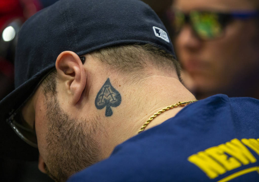 A poker player has the ace of spades tattooed on his neck during the The Big 50, a $500 buy-in, ...