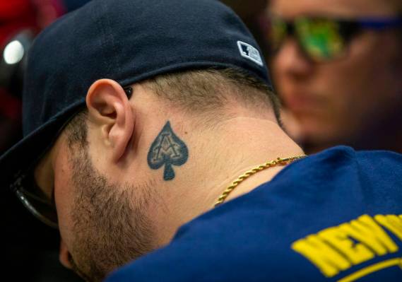 A poker player has the ace of spades tattooed on his neck during the The Big 50, a $500 buy-in, ...