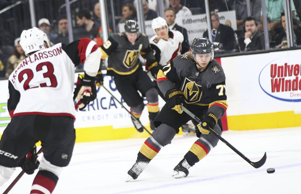 Golden Knights center William Karlsson (71) moves the pack past Arizona Coyotes defenseman Oliv ...