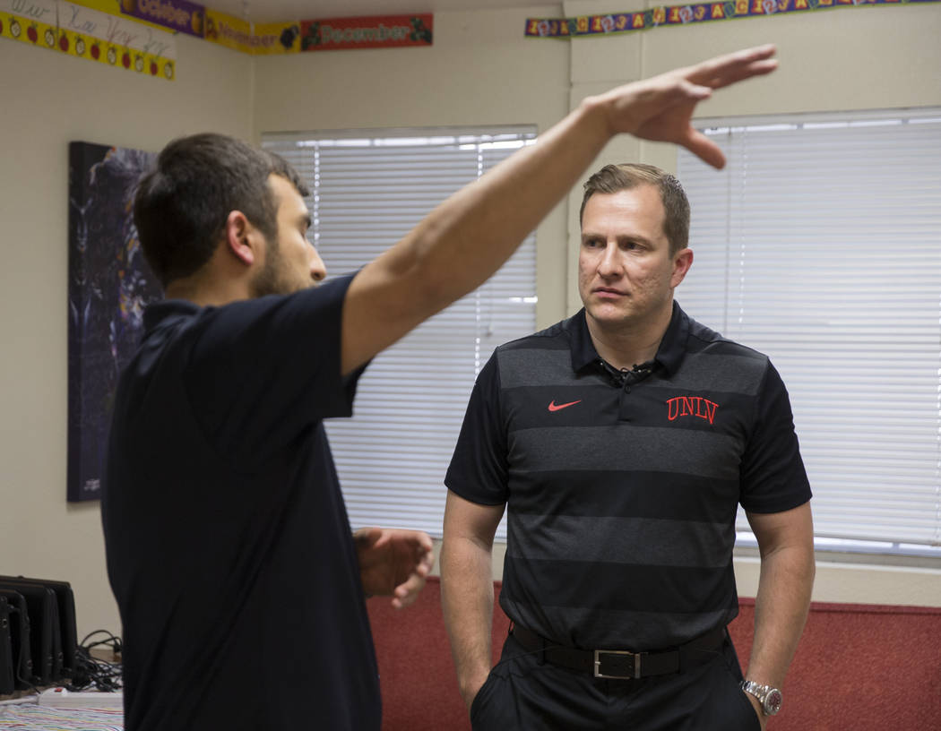 UNLV head basketball coach T.J. Otzelberger, right, speaks with Nevada Youth Network founder Mi ...