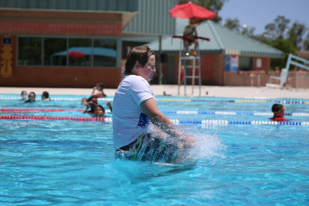 Martin Knopf, 13, leaps into the pool during the annual Ward 4 Summer Splash at the Durango Hil ...