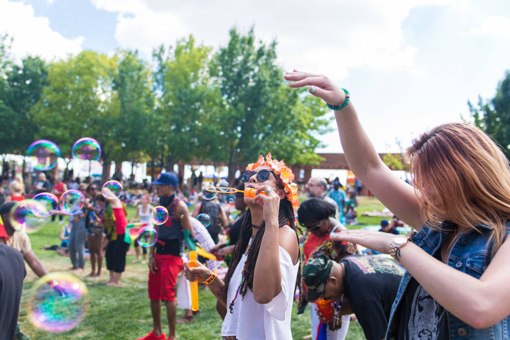 Tiffany Baez from New Jersey blows bubbles during live music at the Clark County Amphitheatre d ...