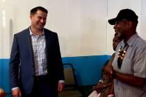 U.S. Rep. Seth Moulton, D-Mass, speaks to Rodney Smith, right, at a veterans town hall meeting ...