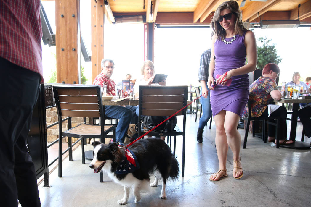 Shelby Giudice with her dog Zuma walk out of the Lazy Dog restaurant in Las Vegas, Friday, May ...