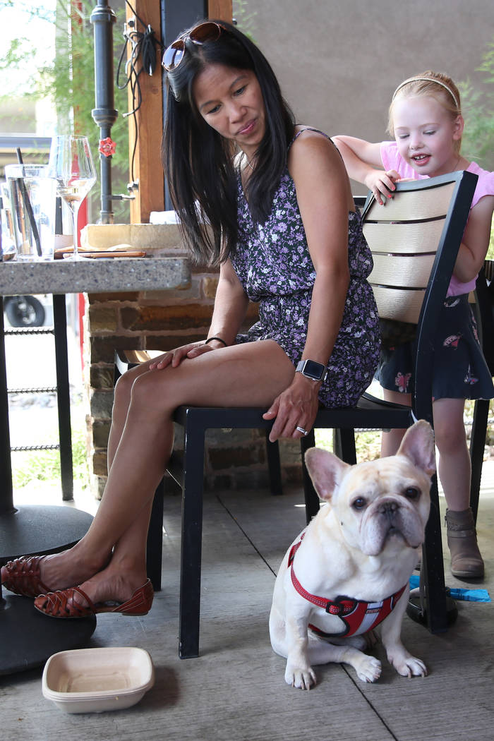 May Benda with her dog Bruiser, and her friend's daughter Fiona Frampton, 6, at Lazy Dog restau ...