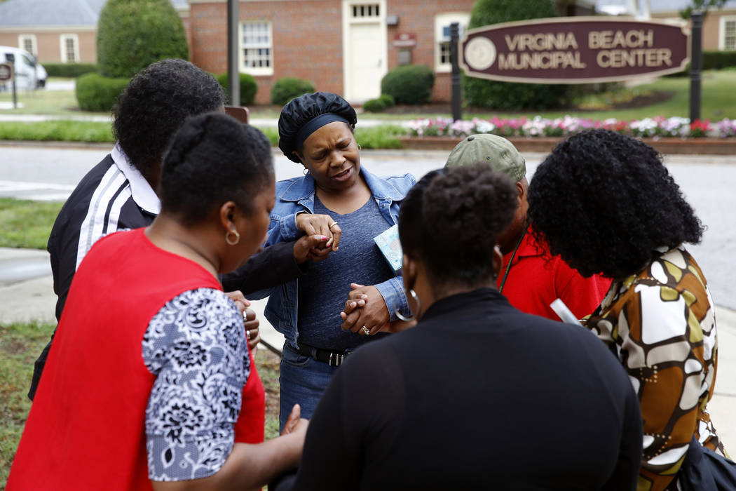 Members of Mount Olive Baptist Church pray near a municipal building that was the scene of a sh ...