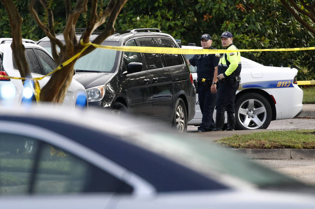 Law enforcement officials work outside a municipal building that was the scene of a shooting, S ...