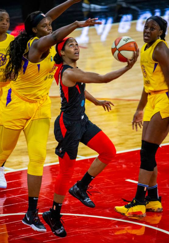 Las Vegas Aces guard Sydney Colson (51) gets off a reverse lay up past Los Angeles Sparks cente ...